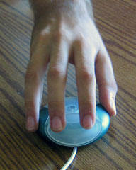 The proper way to hold Apple's round USB puck mouse