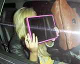 Lindsay Lohan hiding behind her iPad