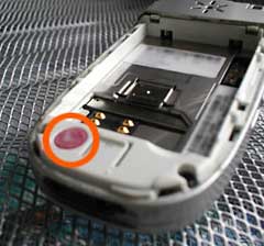 Red water damage spot in Motorola phone